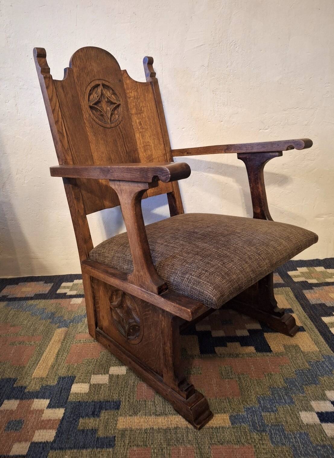 Antique Gothic Revival carved oak armchair, 1910