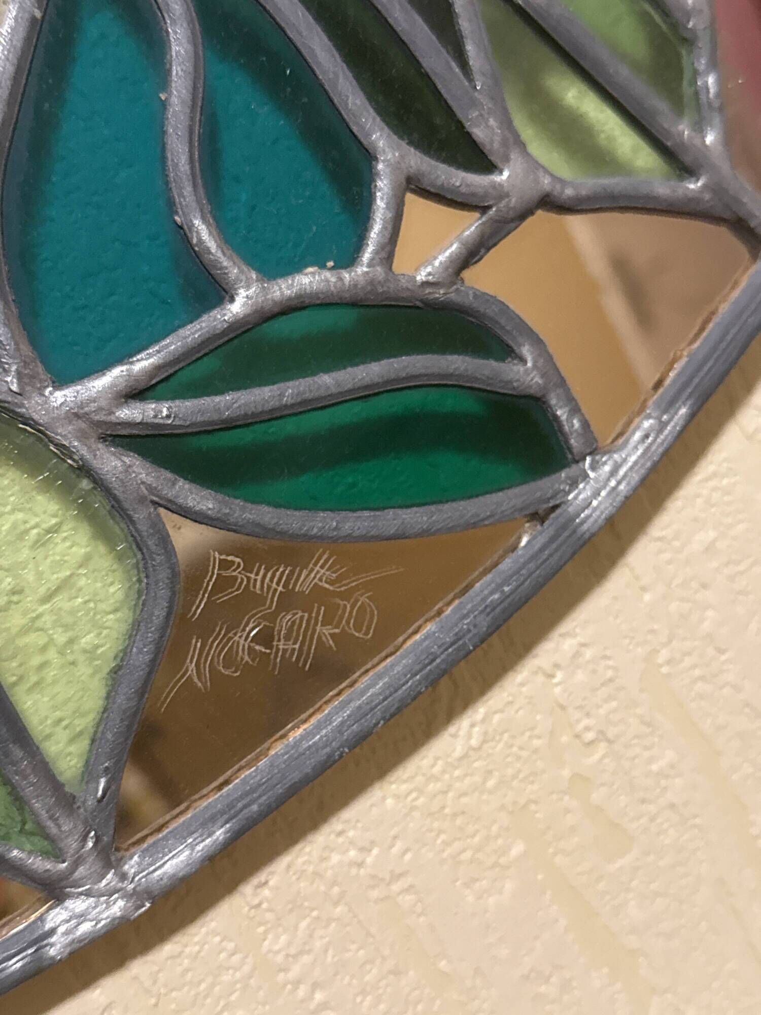 Tiffany stained glass mirror with plant decoration signed B. Nogaro