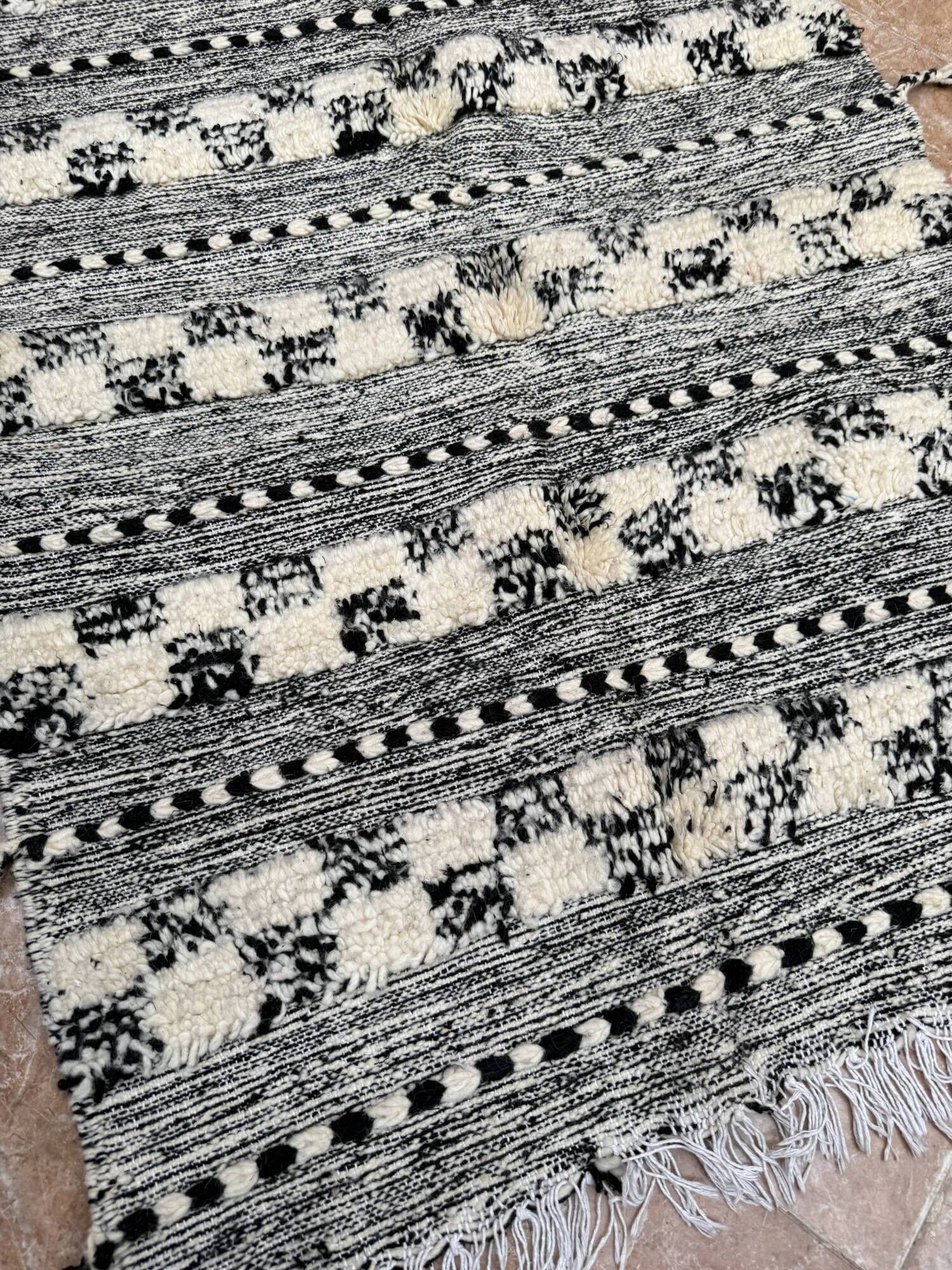 Small black Moroccan Berber Zanafi kilim rug for bedroom and living room.