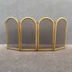 Antique brass fireplace screen from 1920, vintage spark guard.