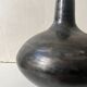 Glazed black ceramic vase with a single stem, signed, circa 1950.