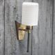 Brass wall light, black lacquered metal and white opal glass, 50s.