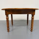 Oval dining table in solid wood with turned legs from the 1950s.