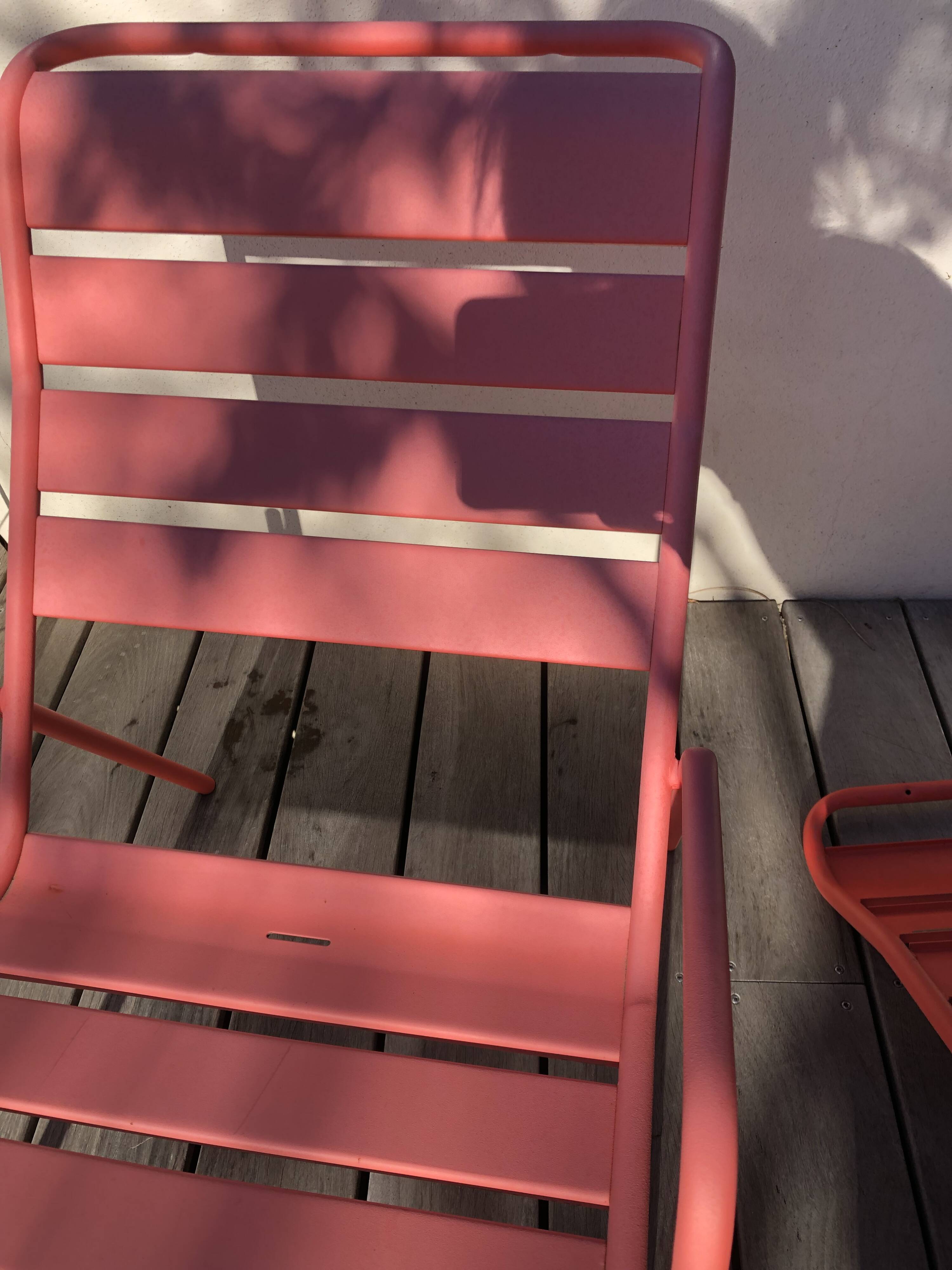 2 low chairs Fermob model Monceau in capucine colour.