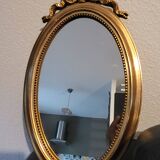 Miroir ovale à noeud doré  en bois