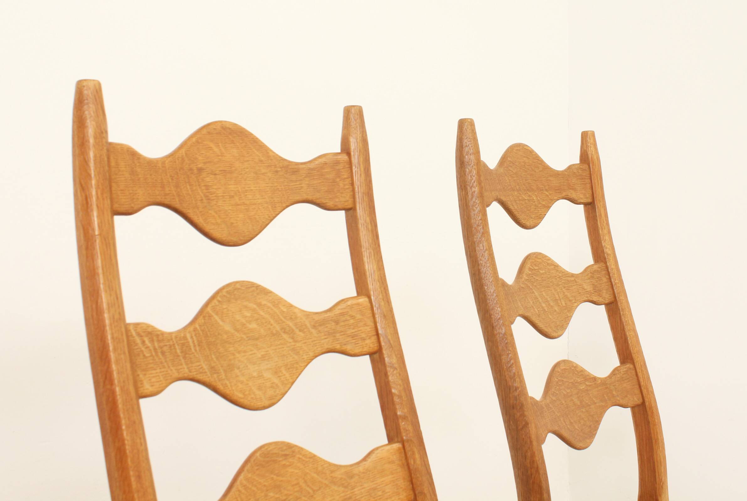 Four oak dining chairs by Henning Kjaernulf.