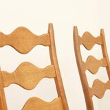 Four oak dining chairs by Henning Kjaernulf.