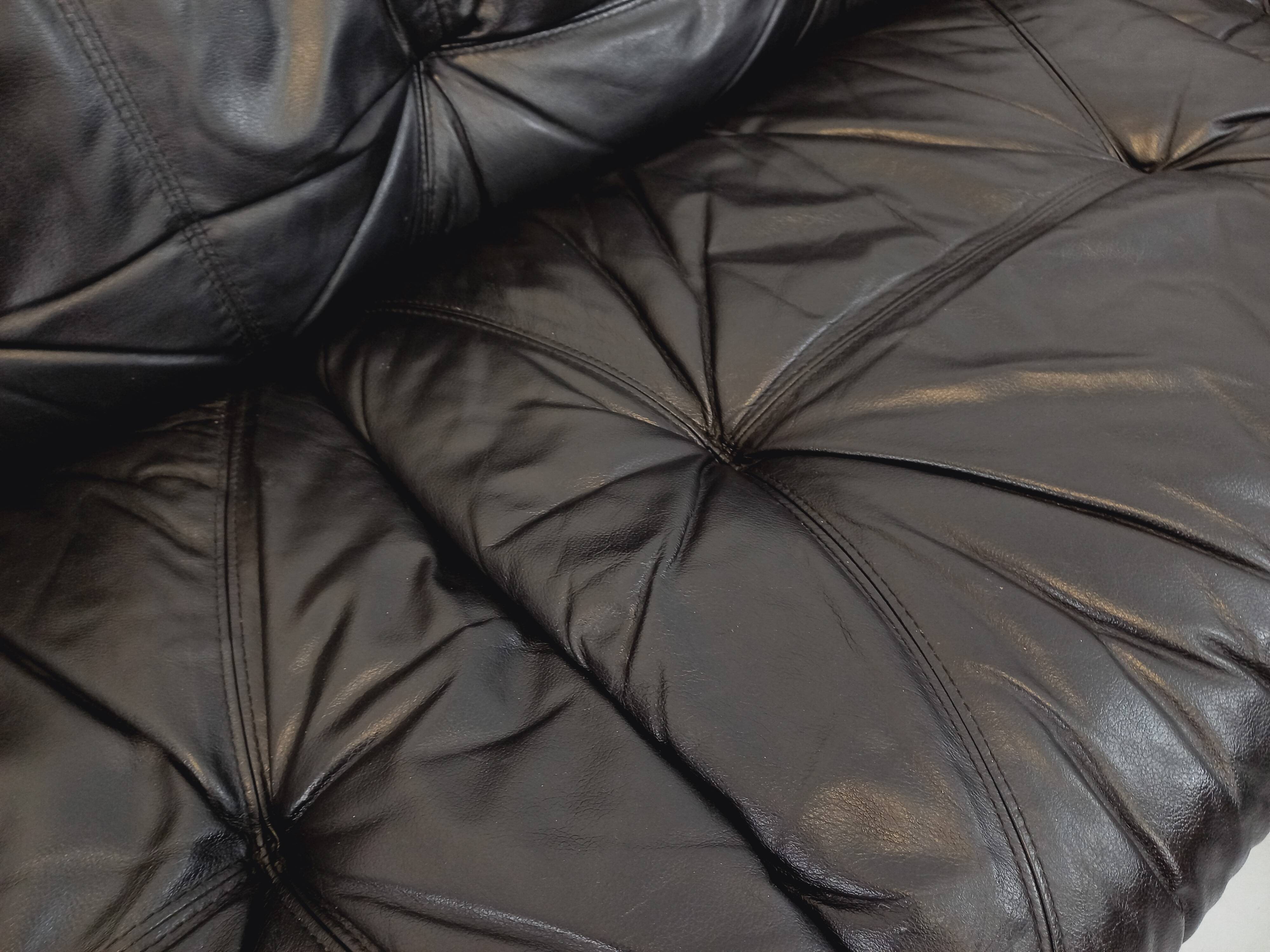 Vintage corner sofa composed of 3 modules in black leather with integrated bed.