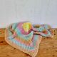 Vintage pastel crochet blanket for children.