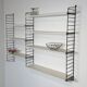 Vintage Nisse Strinning wall rack with 7 white shelves