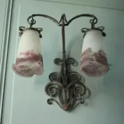 Wall lamp in wrought iron with a pink tulip glass globe by Muller glassworks.