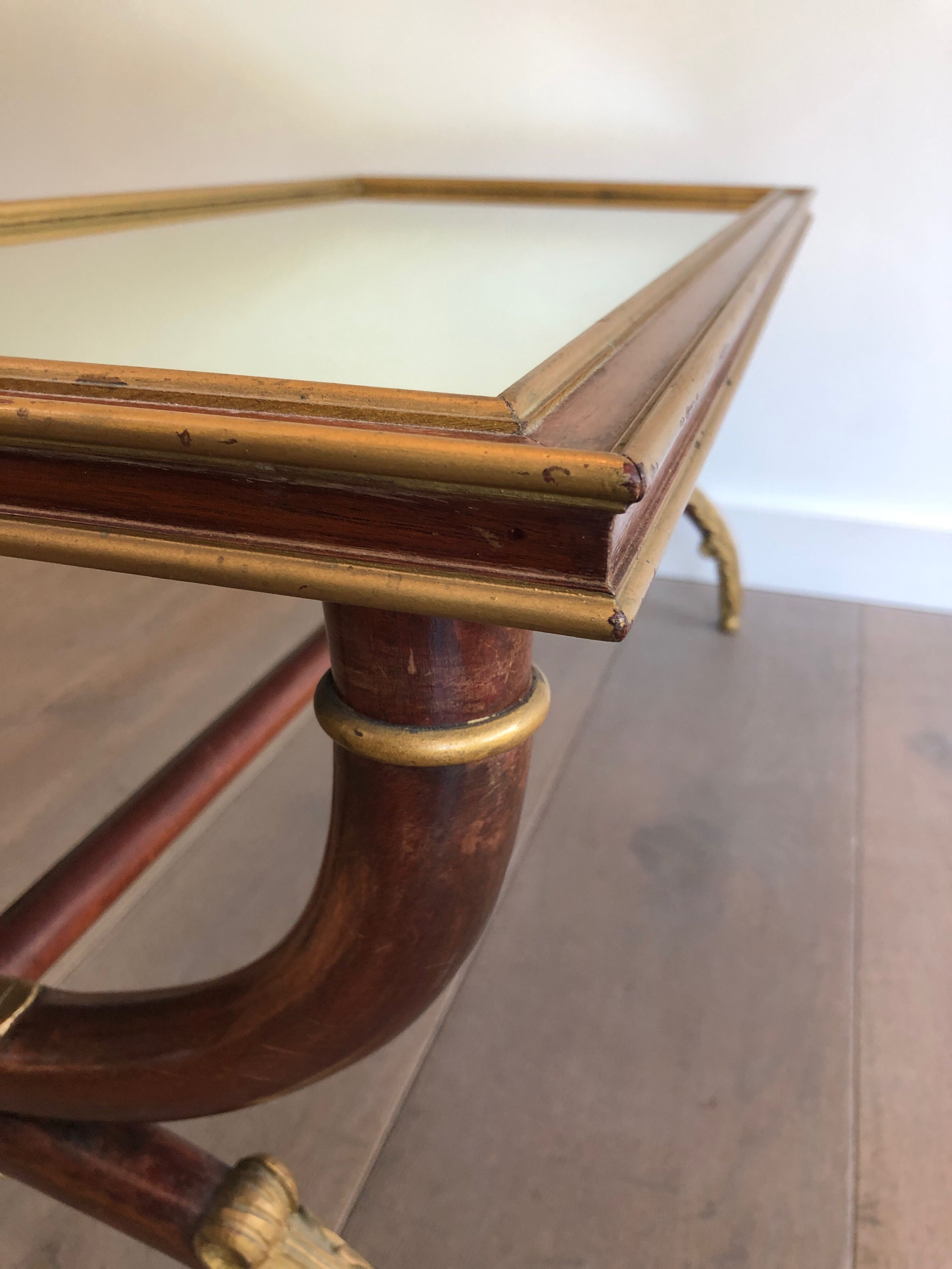 Coffee table in patinated and gilded carved wood with mirror top