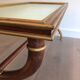 Coffee table in patinated and gilded carved wood with mirror top