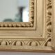 Antique mirror with a gilded frame and beaded border.