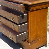 Chest of drawers with decorated handles in the Louis XVI style.