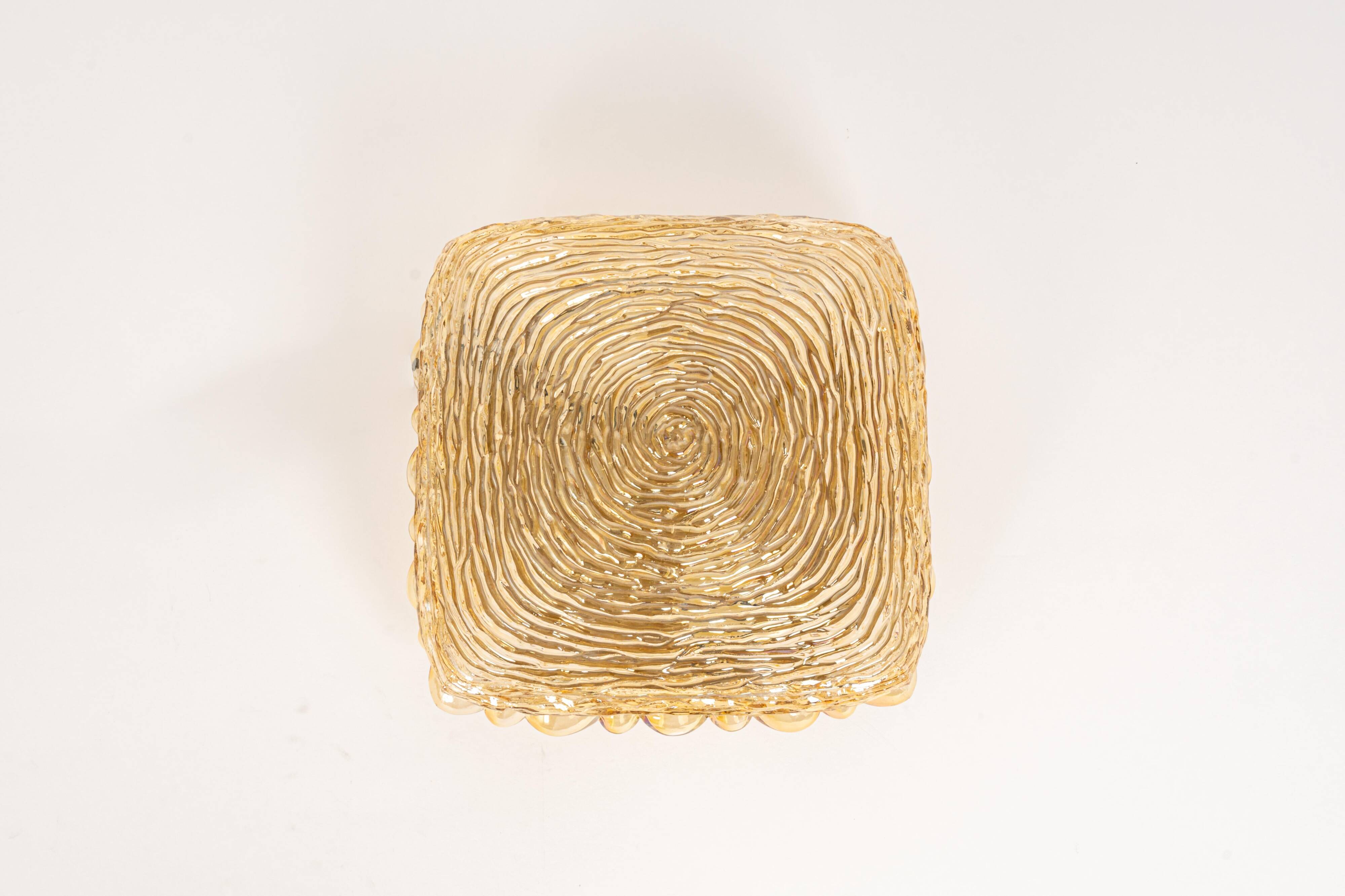 Amber glass wall light in the shape of a fingerprint, Germany, 1970s.