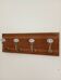 Wall-mounted coat rack with 4 ceramic hooks in blue and white, vintage style.