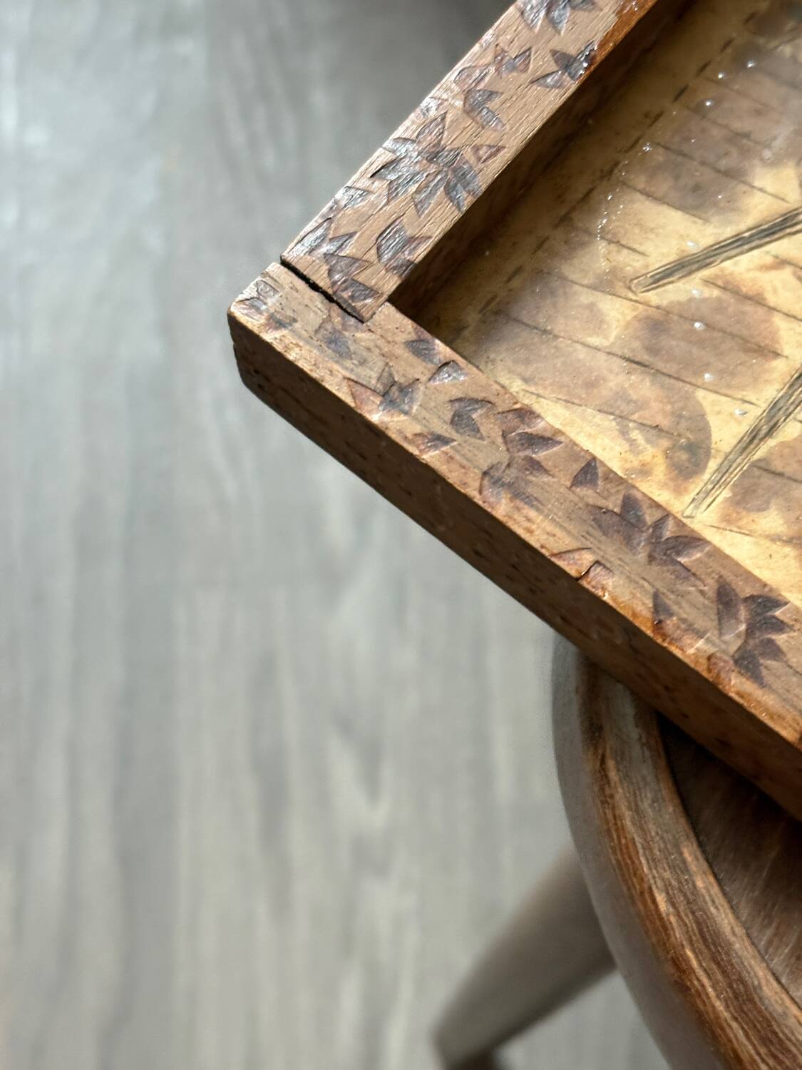Antique wooden tray depicting a family scene
