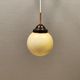 Small Art Deco hanging lamp in cream coloured glass and bakelite top.