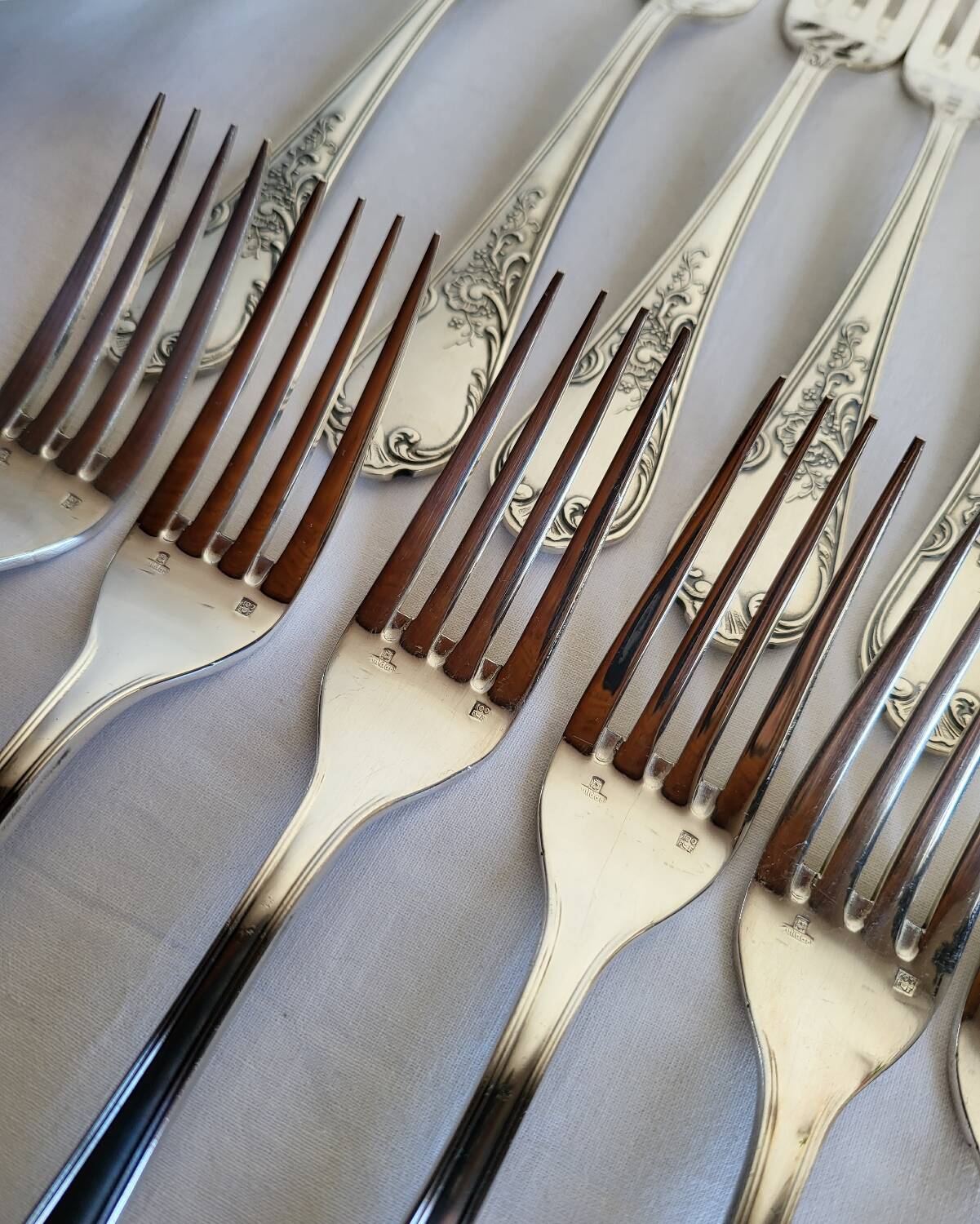 12 large silver-plated metal table forks by Guildart