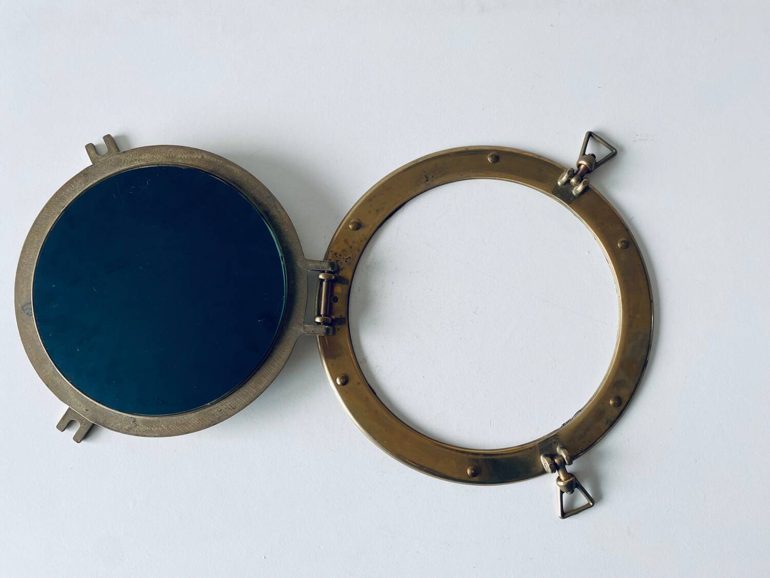 Porthole mirror in gilded brass