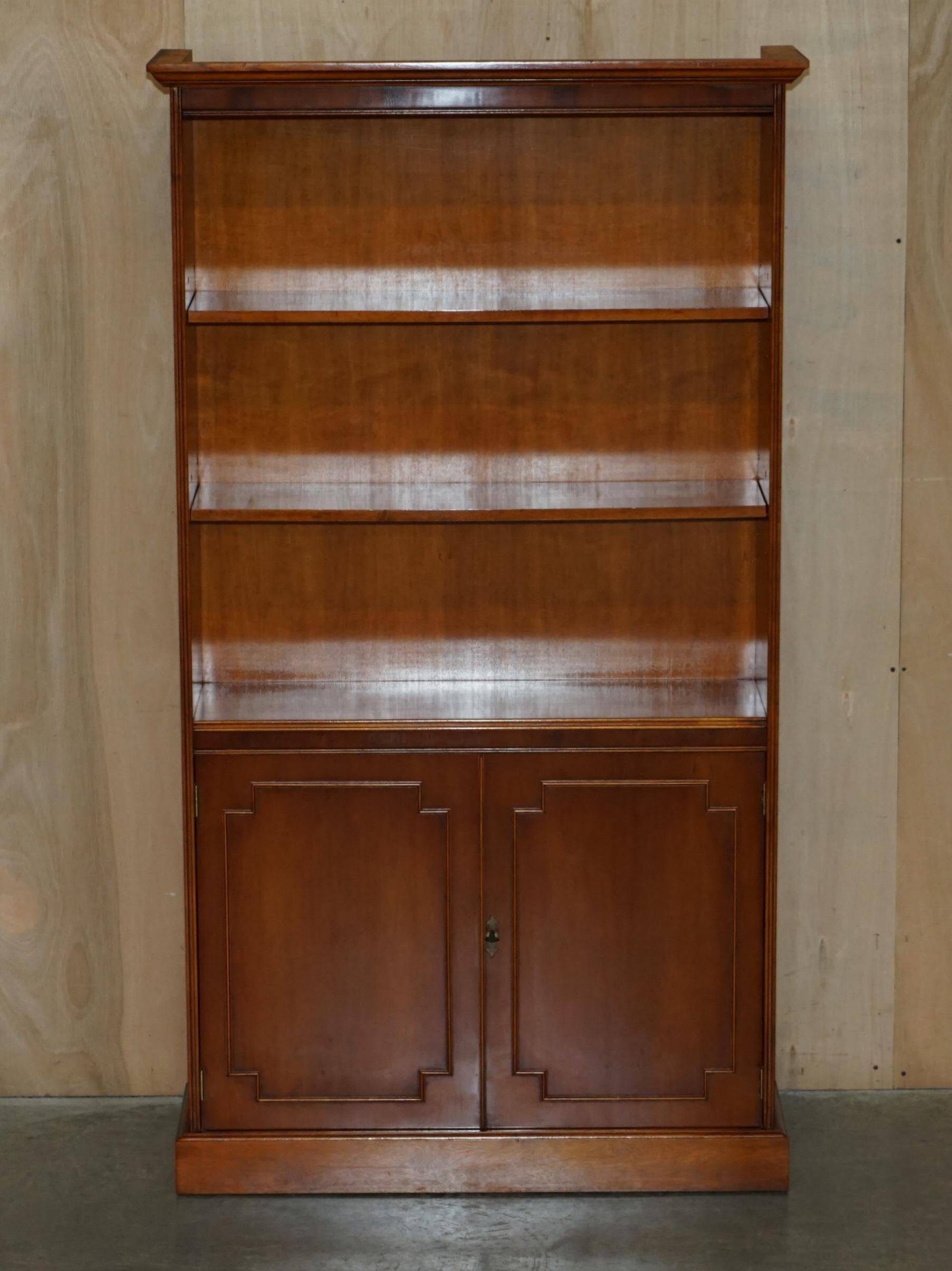 Open library Bradley Furniture made of yew wood with a cupboard base.