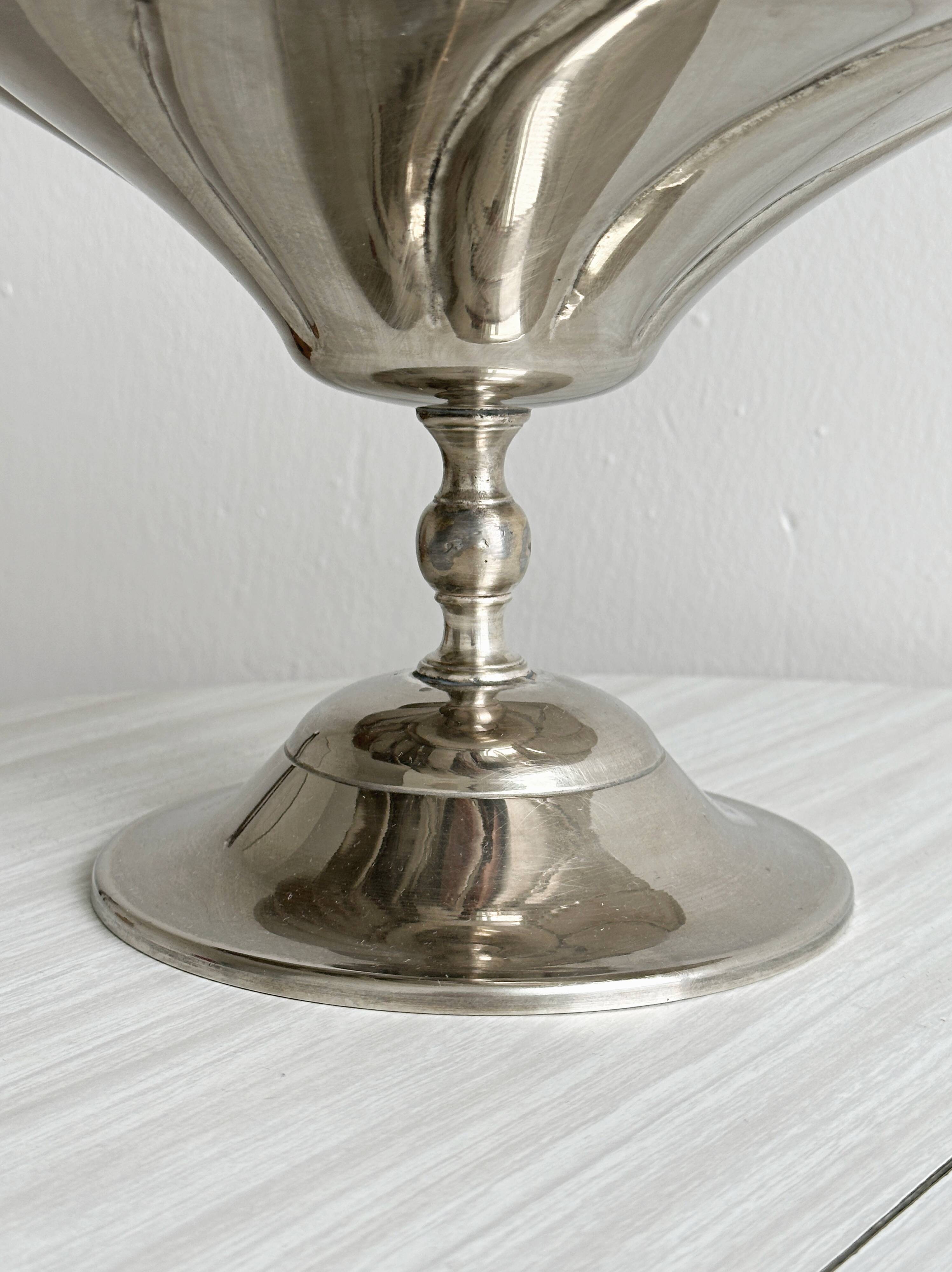 large dish on a shiny metal stand