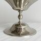 large dish on a shiny metal stand