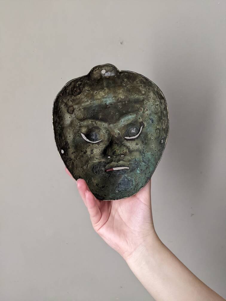 Ancient Indonesian bronze mask antique ethnic decoration tribal theater