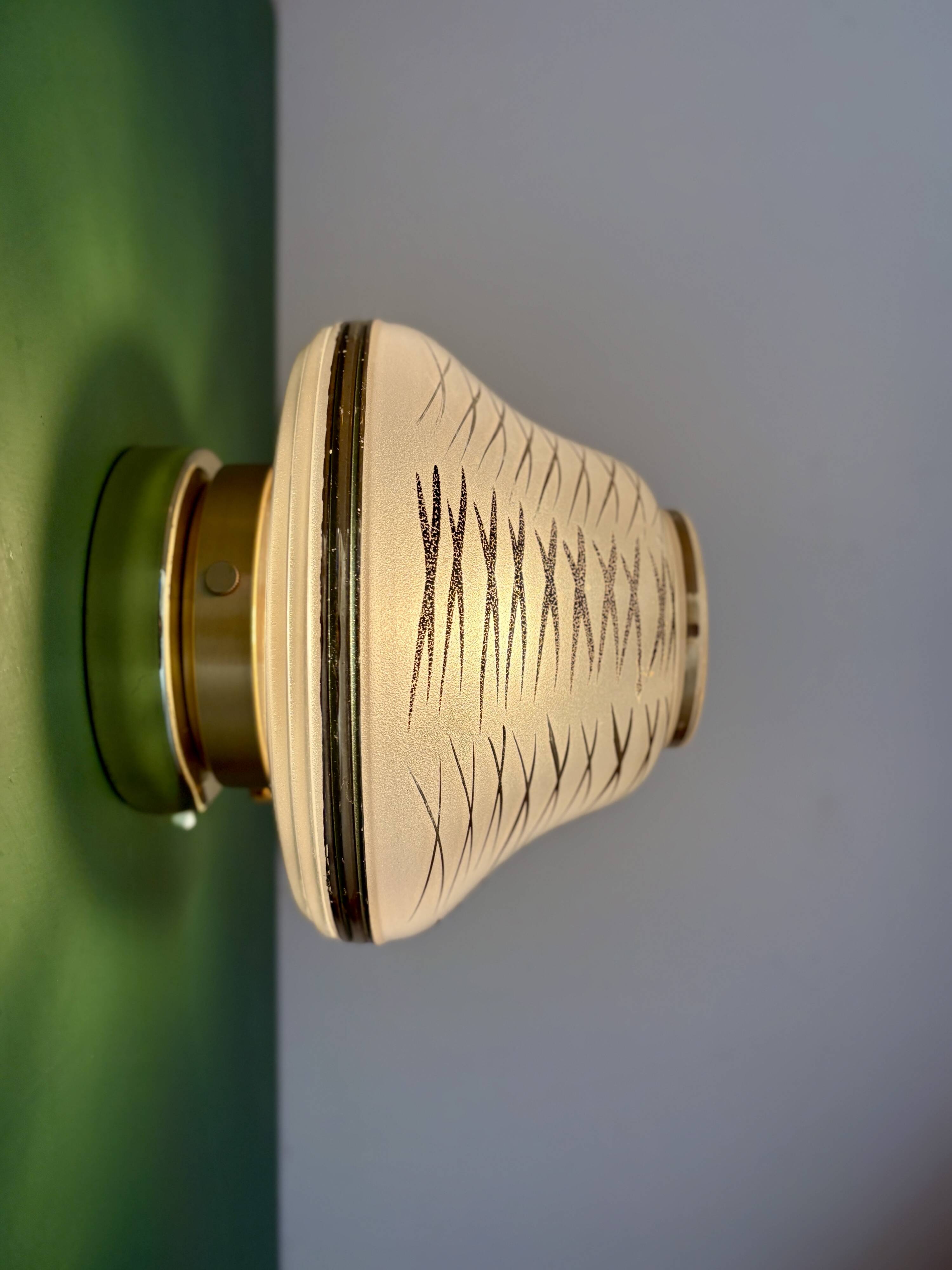 Vintage Art Deco globe wall/ceiling light in white, black, and gold glass.