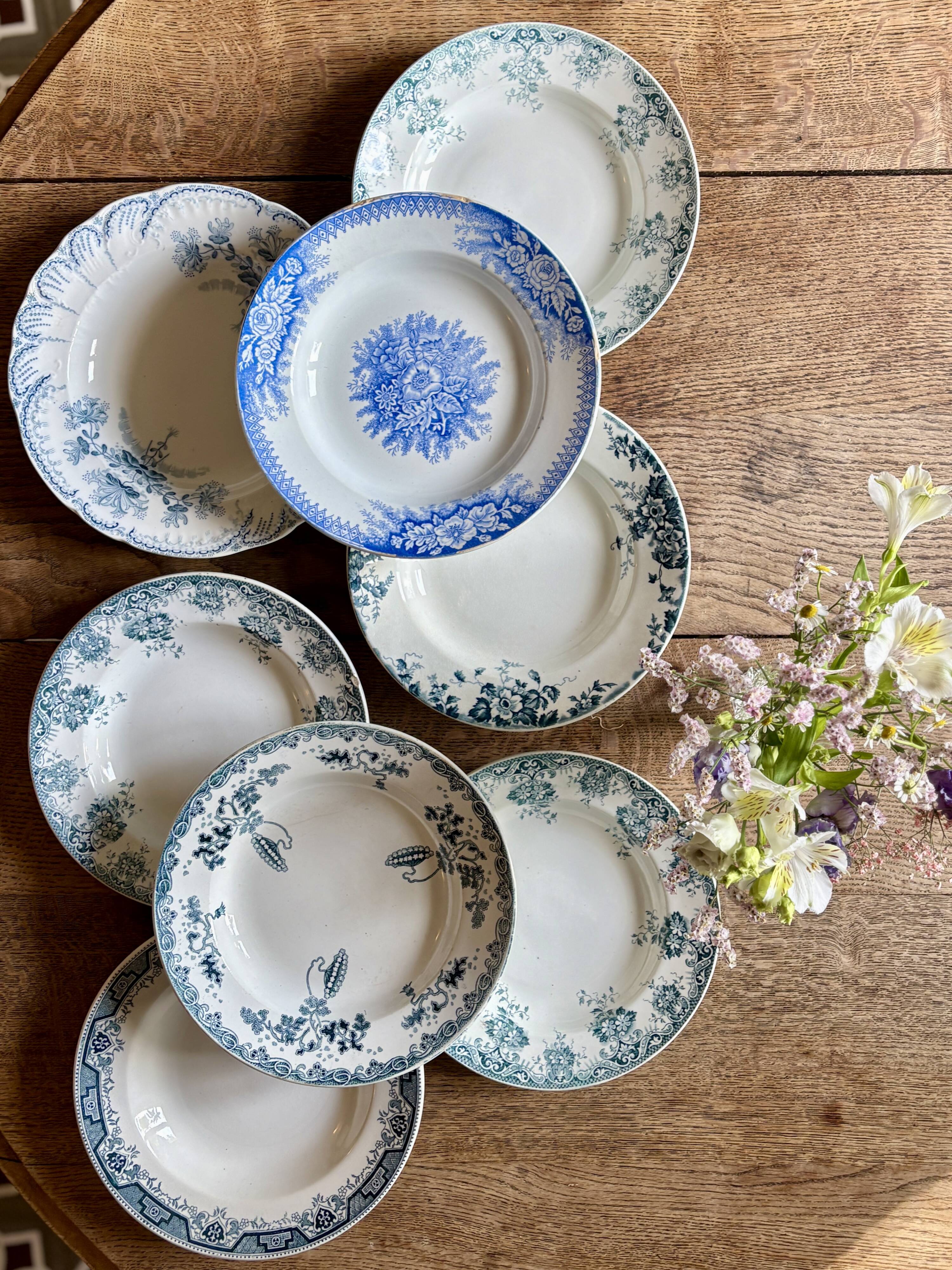 Set of 8 mismatched antique ironstone deep plates.