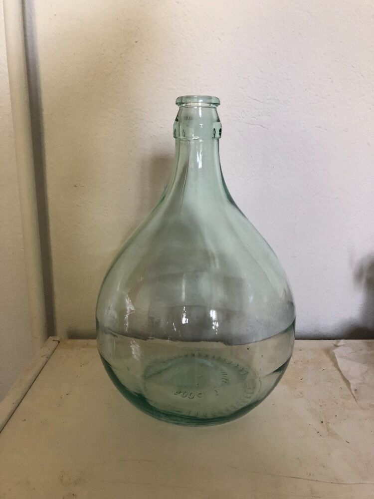 Demijohn in glass with light blue reflection