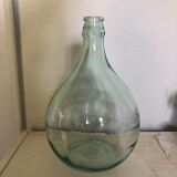 Demijohn in glass with light blue reflection