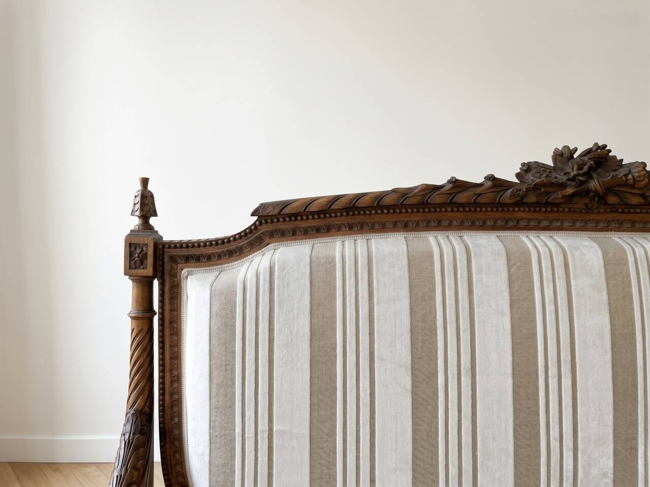 Louis XV style classic canapé reupholstered in striped beige fabric.