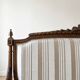 Louis XV style classic canapé reupholstered in striped beige fabric.