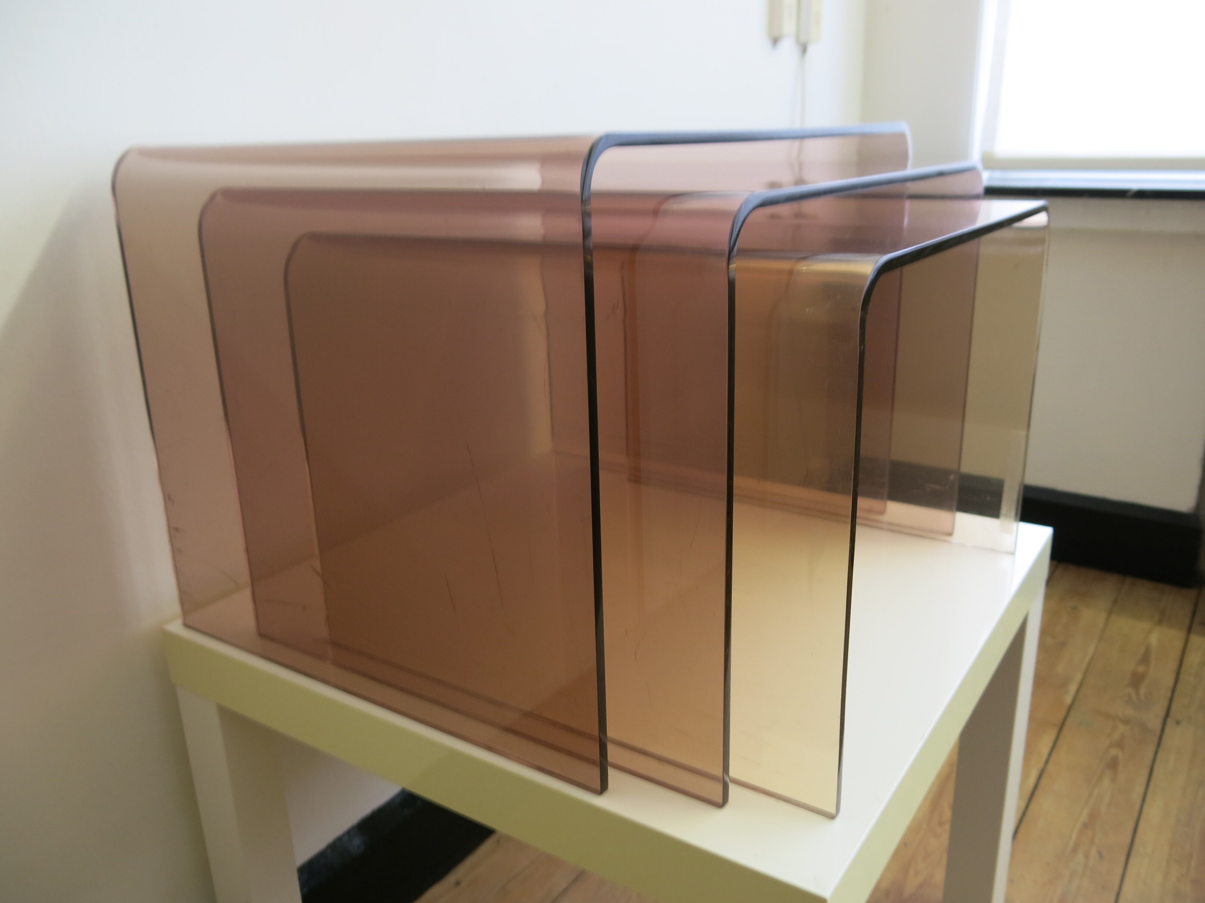 Trio of plexi nesting tables signed Michel Dumas