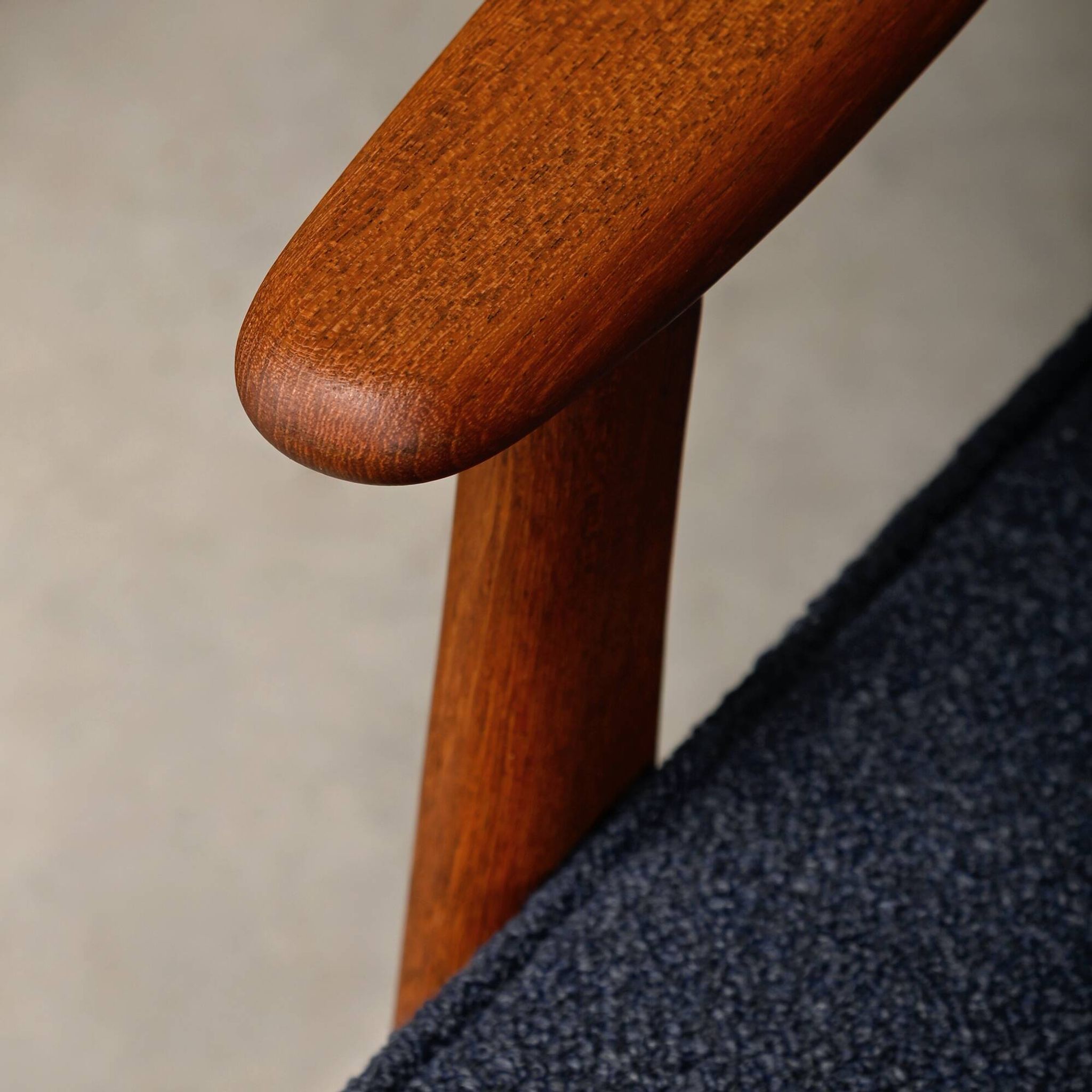Pair Scandinavian Modern armchairs in teak and dark blue bouclé fabric