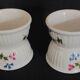 Pair of porcelain diabolo egg cups decorated with 20th century barbels