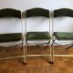 Set of three vintage green folding chairs