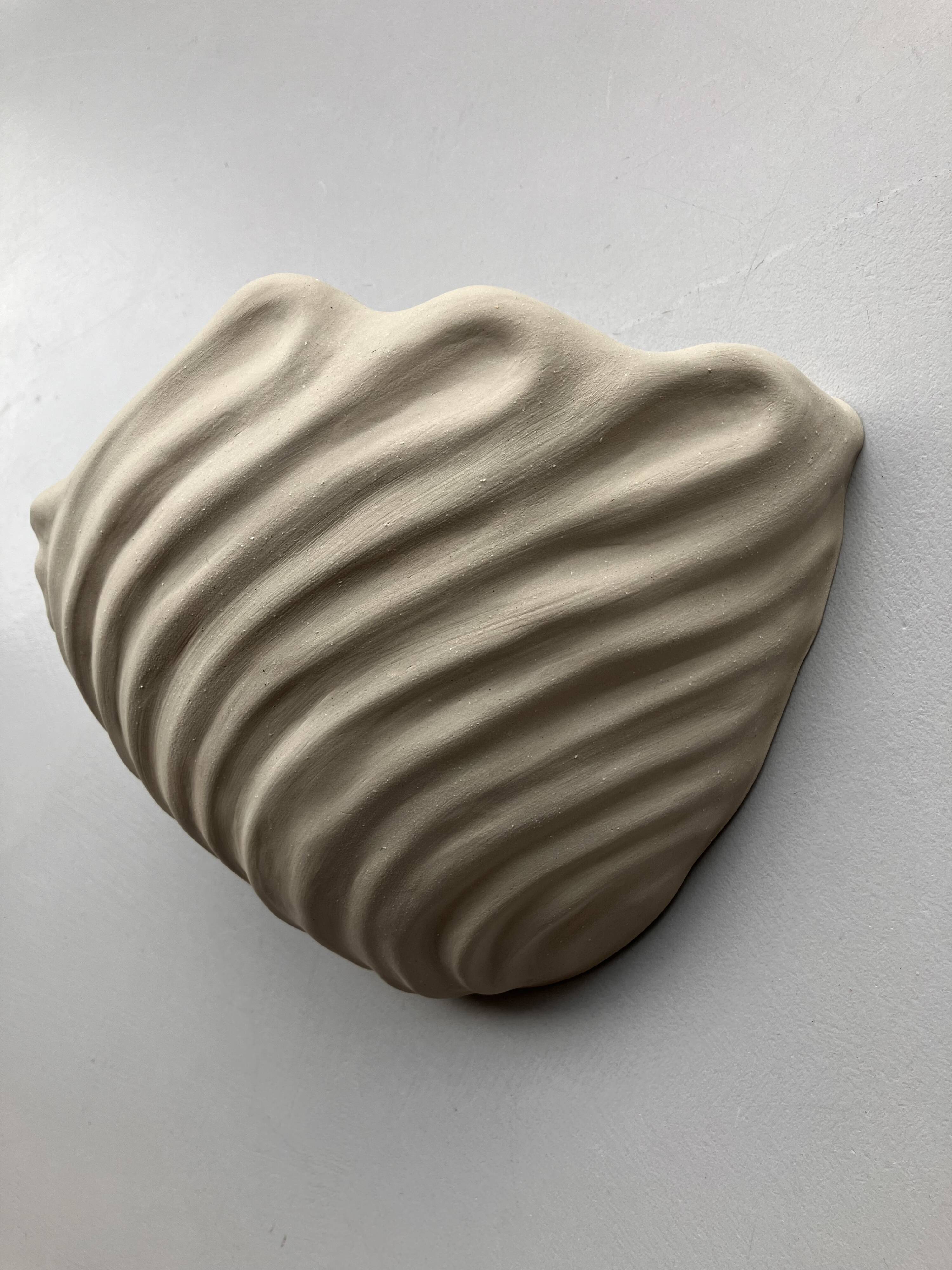 Shell-shaped ceramic applique handcrafted.