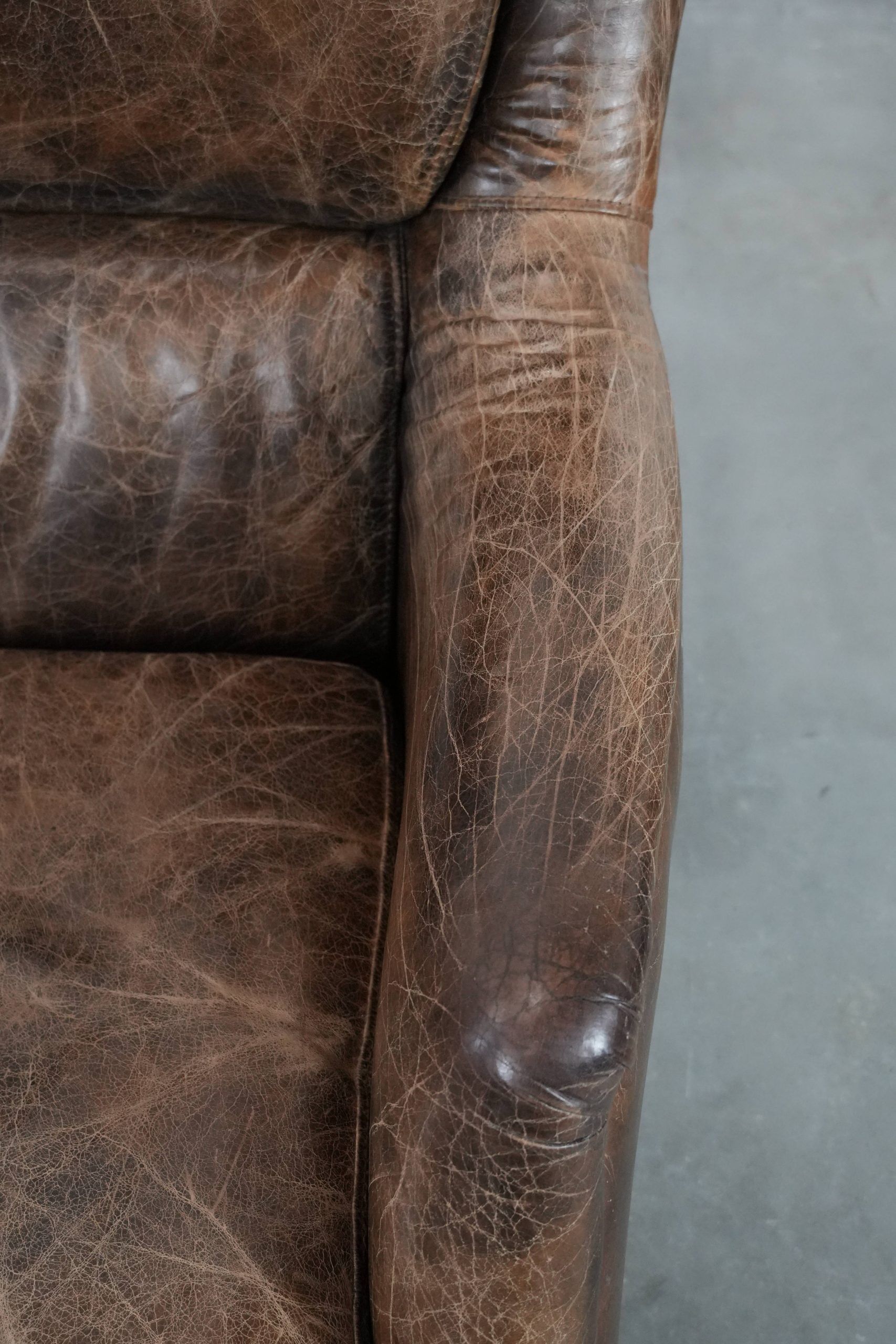 Very comfortable vintage cow leather armchair with character