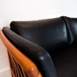 Two seater sofa upholstered with black leather and of danish design