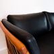 Two seater sofa upholstered with black leather and of danish design