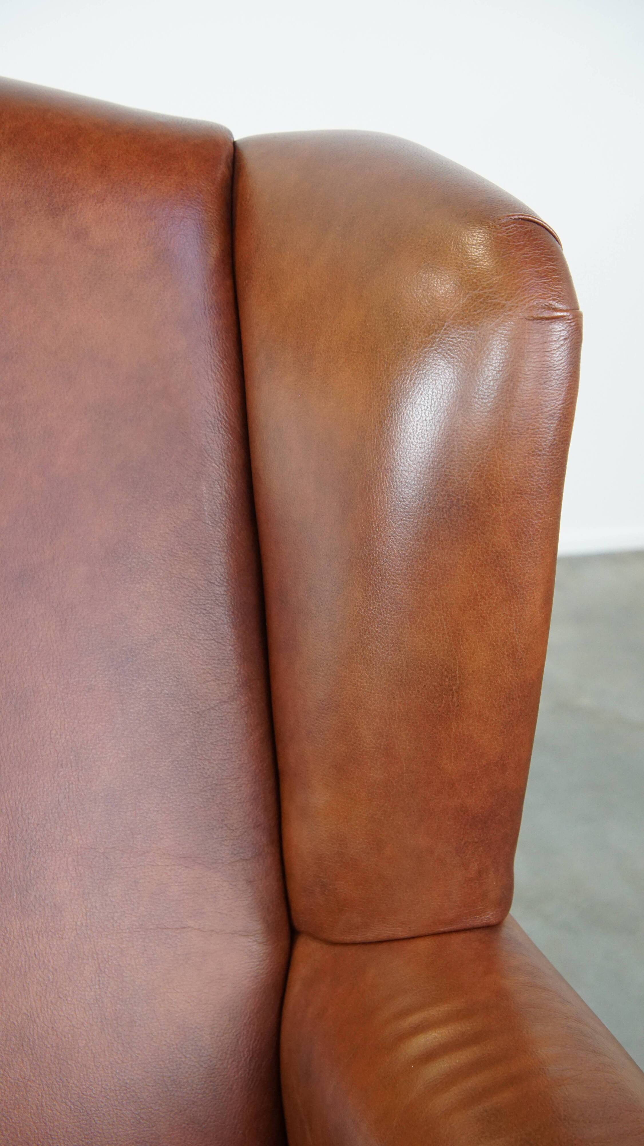 Cognac-colored cowhide wingback chair