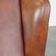 Cognac-colored cowhide wingback chair