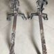 Pair of bronze fireplace firedogs with fleur-de-lys decor, art deco