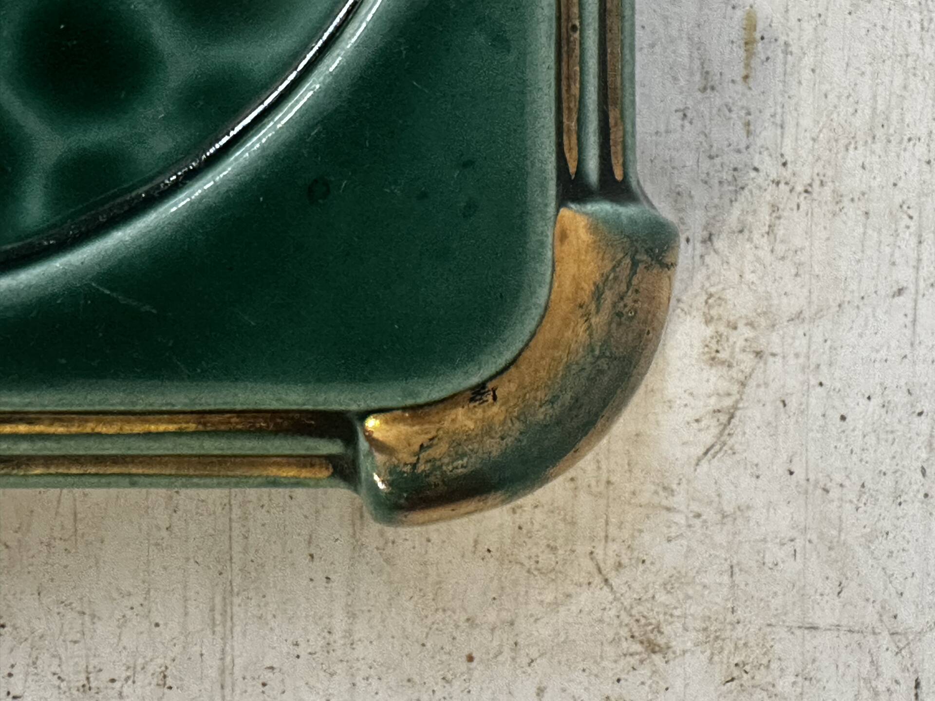 Art Deco bottle coaster in speckled green glazed ceramic and
