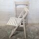 Pair of white wooden folding chairs