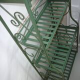 Folding green wrought iron shelf