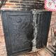 huge old fireplace plate has decoration of angels, crown and fleurs-de-lis
